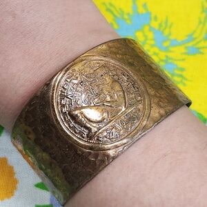 Vintage 70s Egyptian Revival Hammered Brass Cuff Bracelet with Medallion Design